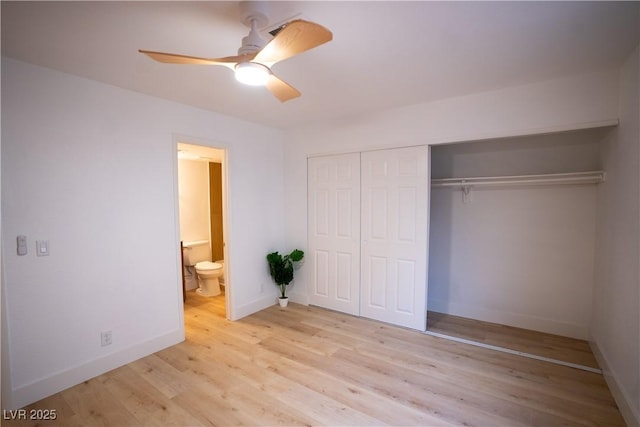 unfurnished bedroom featuring a closet, light wood-style flooring, a ceiling fan, ensuite bath, and baseboards