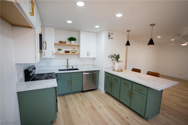 kitchen with white cabinets, appliances with stainless steel finishes, green cabinets, and a sink