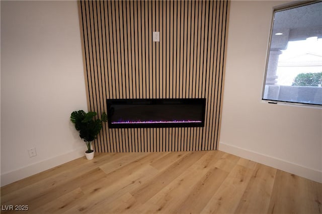 room details featuring baseboards and wood finished floors