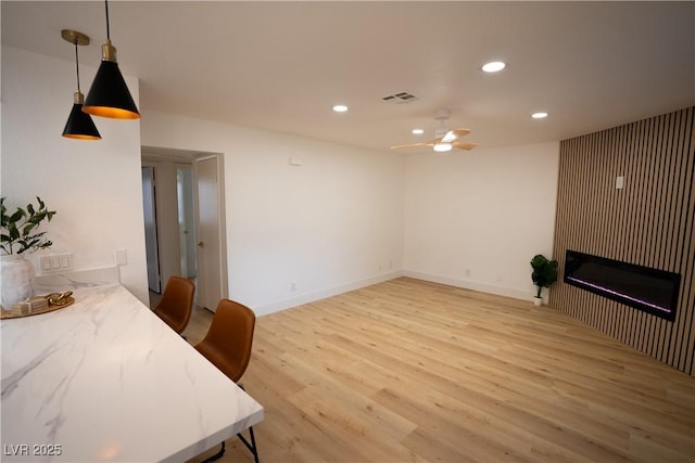 interior space with visible vents, baseboards, ceiling fan, light wood-type flooring, and recessed lighting