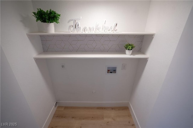 laundry room with hookup for a washing machine, light wood-style flooring, hookup for an electric dryer, laundry area, and baseboards