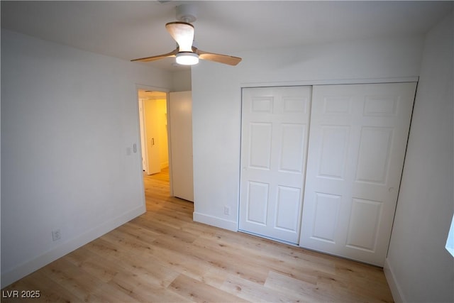 unfurnished bedroom featuring light wood-style floors, a closet, ceiling fan, and baseboards