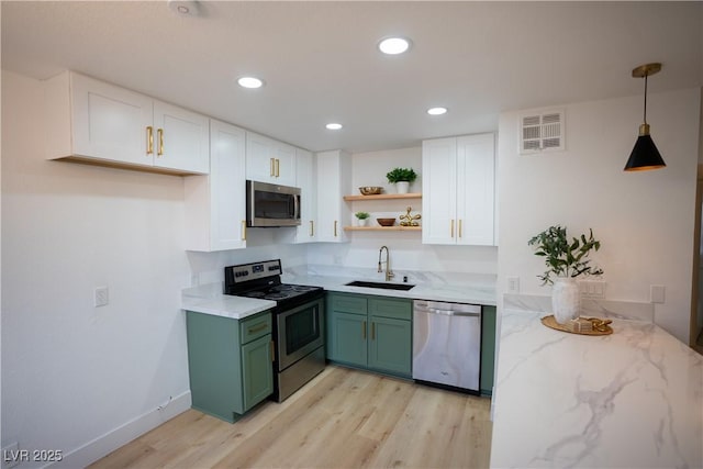 kitchen featuring a sink, white cabinetry, appliances with stainless steel finishes, open shelves, and green cabinetry