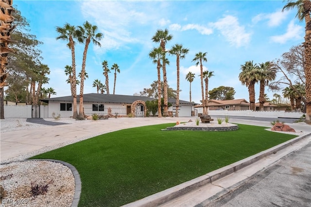 ranch-style home with fence and a front lawn