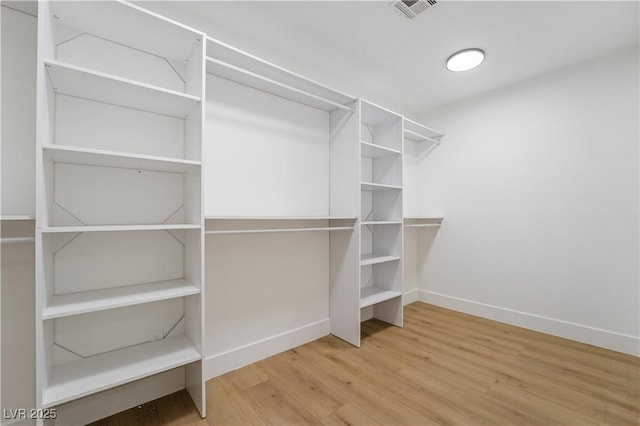 spacious closet with visible vents and wood finished floors