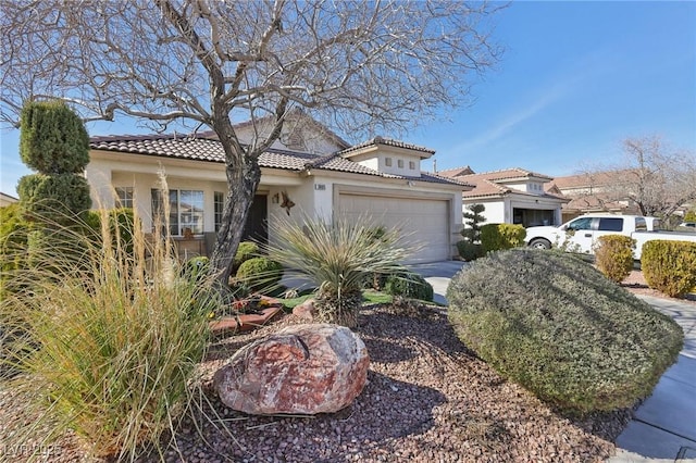 mediterranean / spanish-style home with a garage, a tile roof, concrete driveway, and stucco siding