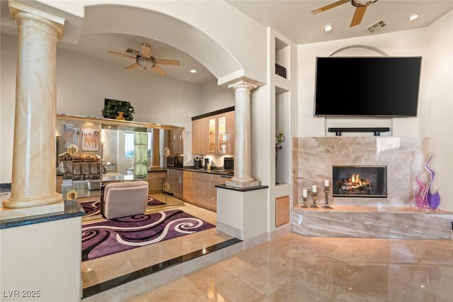 living room with ceiling fan, recessed lighting, visible vents, and ornate columns