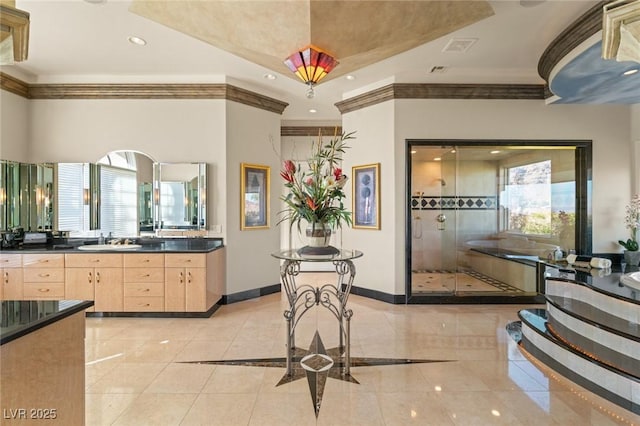 interior space featuring crown molding, recessed lighting, a shower stall, vanity, and baseboards