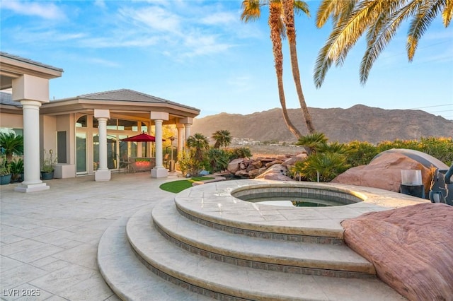 exterior space with a patio area, a mountain view, and a gazebo