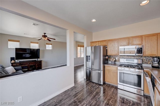 kitchen with dark wood-style flooring, tasteful backsplash, visible vents, appliances with stainless steel finishes, and open floor plan