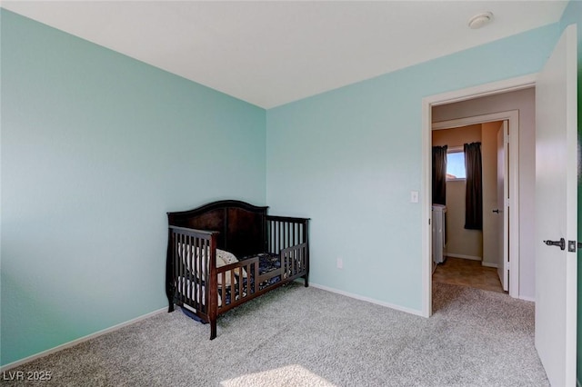 bedroom with light carpet, a nursery area, and baseboards