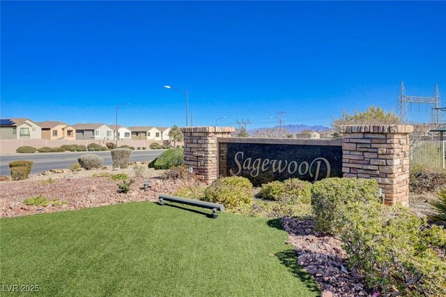 community / neighborhood sign with a residential view and a lawn