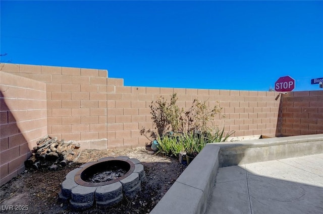 view of yard with a fire pit and a fenced backyard