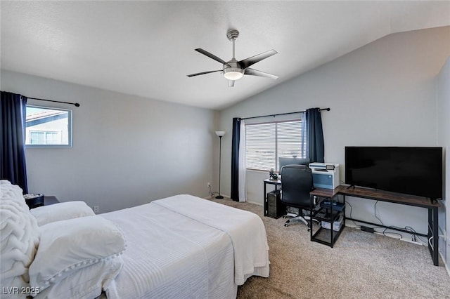 bedroom featuring ceiling fan, vaulted ceiling, and light colored carpet