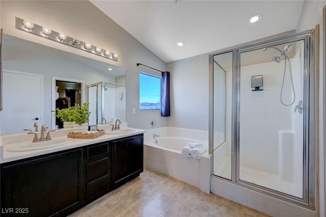 bathroom with lofted ceiling, a sink, a shower stall, a bath, and double vanity