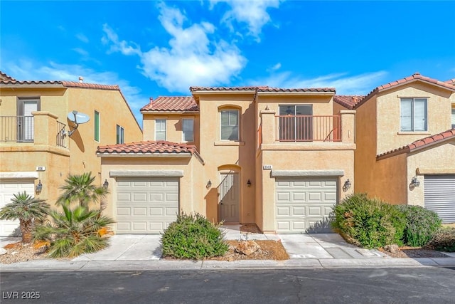 mediterranean / spanish-style home featuring a garage, concrete driveway, a balcony, and stucco siding