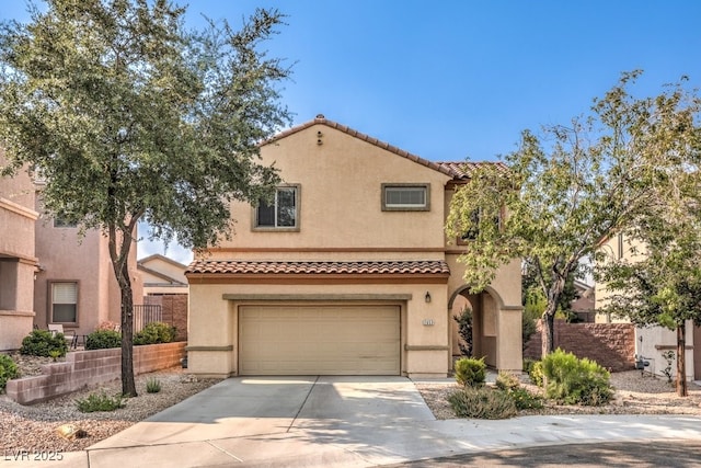 mediterranean / spanish-style house with a garage, a tile roof, fence, concrete driveway, and stucco siding