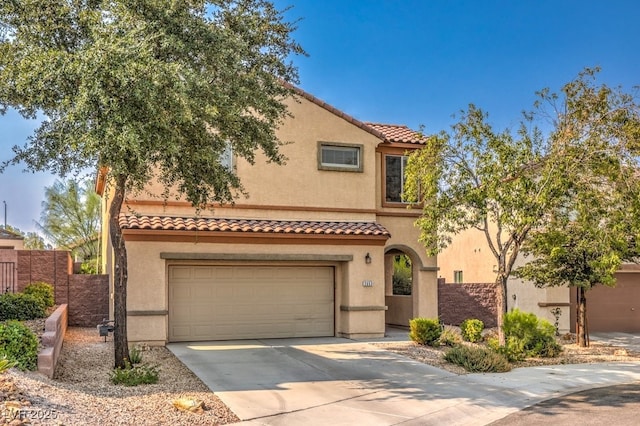 mediterranean / spanish-style home featuring a garage, driveway, a tile roof, and stucco siding