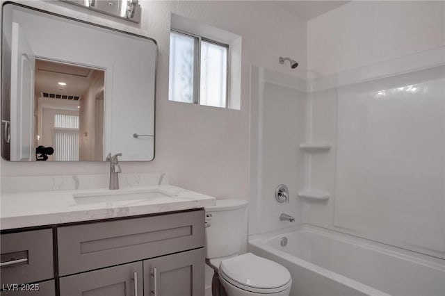 bathroom featuring toilet, washtub / shower combination, visible vents, and vanity