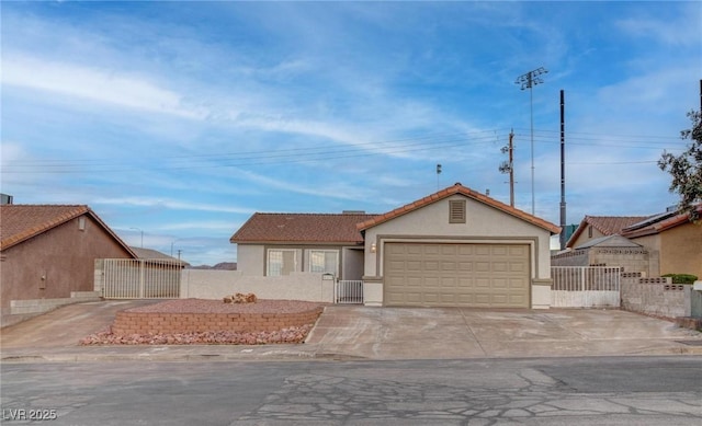 view of front facade with driveway, an attached garage, fence, and stucco siding