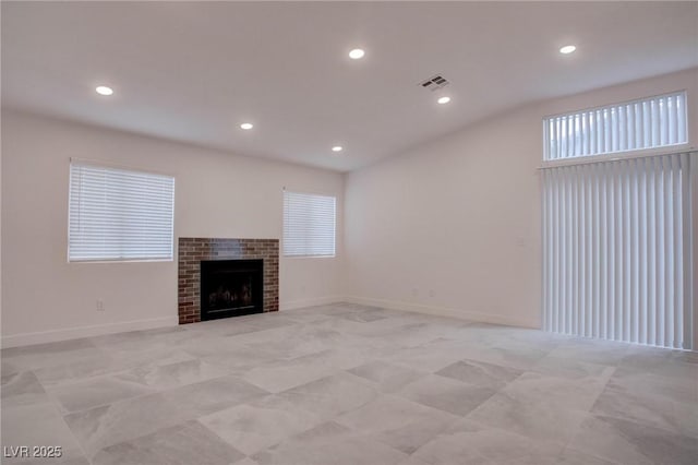 unfurnished living room featuring recessed lighting, a fireplace, visible vents, and baseboards