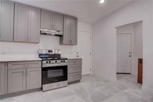 kitchen featuring light countertops, under cabinet range hood, gray cabinetry, and stainless steel electric stove