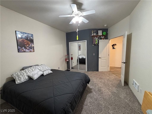 carpeted bedroom featuring visible vents, a closet, and ceiling fan