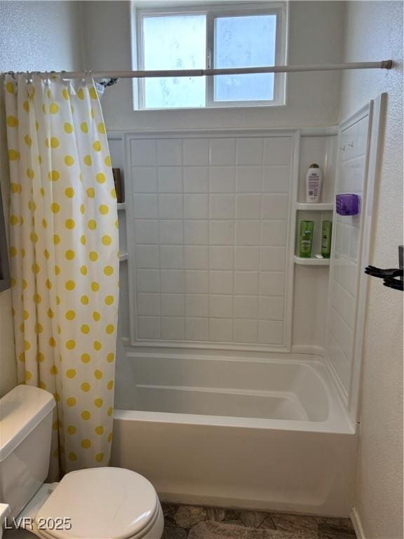 bathroom with toilet, shower / bathtub combination with curtain, and a textured wall