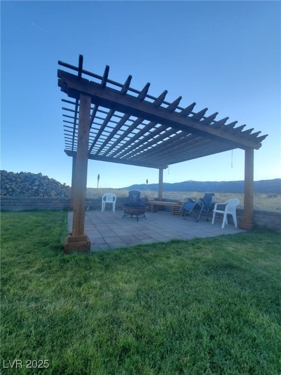 exterior space featuring a patio area, a lawn, and a pergola