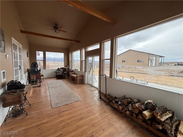 sunroom featuring vaulted ceiling with beams and ceiling fan