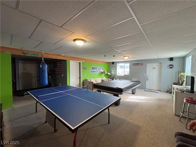 recreation room with a drop ceiling and carpet floors