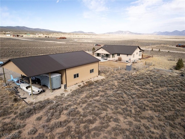 birds eye view of property featuring a desert view and a mountain view