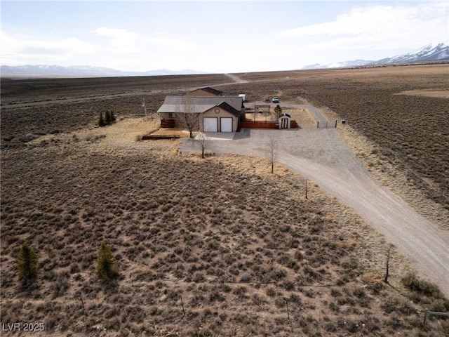 birds eye view of property featuring a mountain view and a rural view
