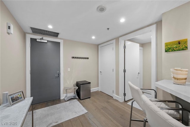 entrance foyer with light wood-type flooring, baseboards, visible vents, and recessed lighting