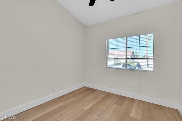 unfurnished room featuring ceiling fan, vaulted ceiling, light wood-style flooring, and baseboards