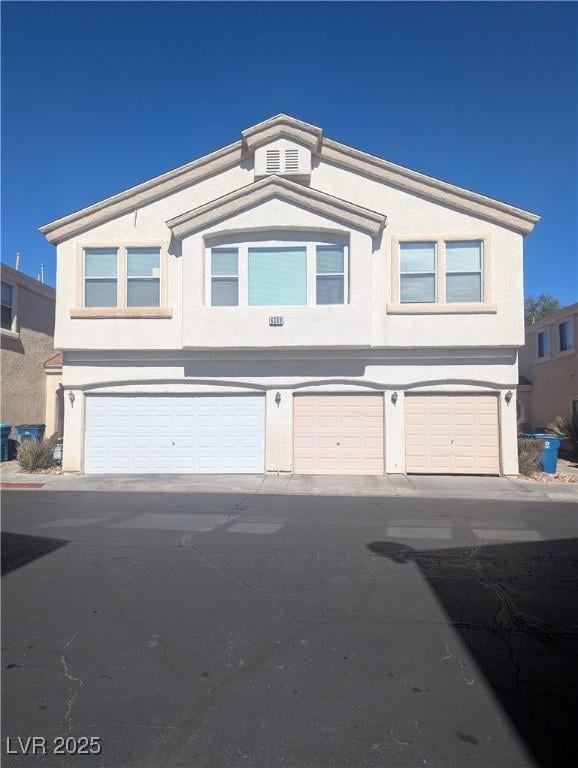 view of front facade featuring an attached garage and stucco siding