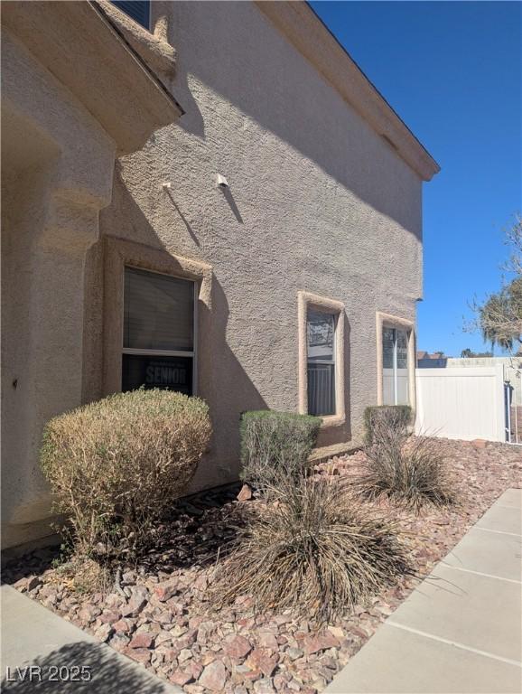 exterior space with fence and stucco siding