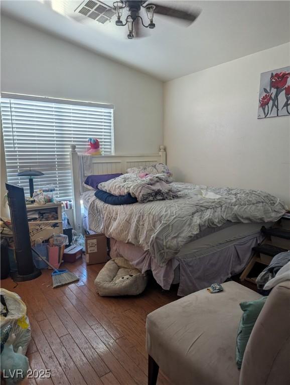 bedroom featuring a ceiling fan, dark wood-style flooring, and visible vents