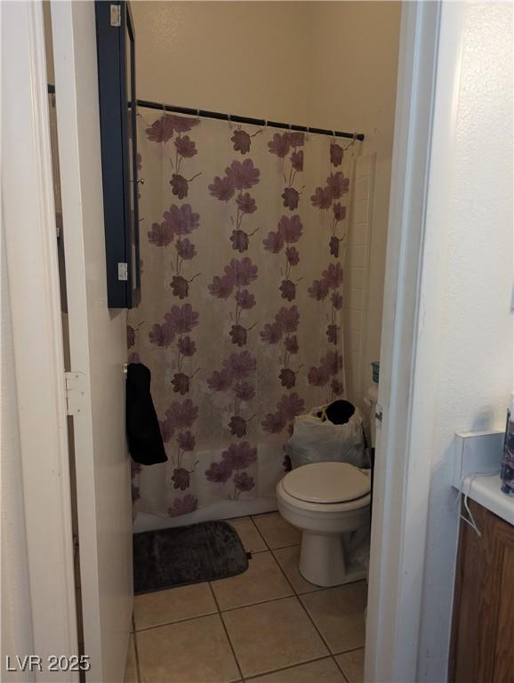 bathroom featuring toilet, vanity, shower / bathing tub combination, and tile patterned floors