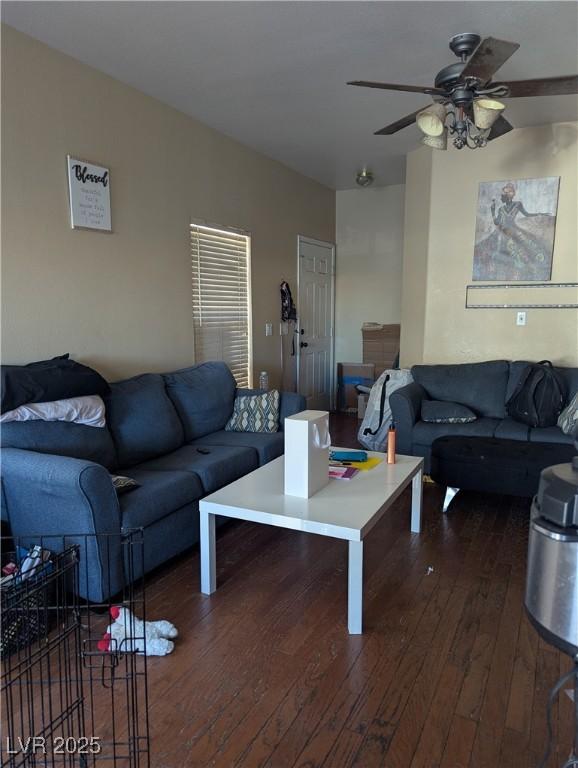 living room with dark wood-type flooring and ceiling fan