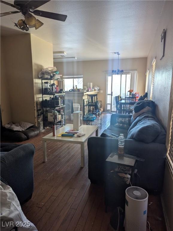 living room featuring ceiling fan, plenty of natural light, and wood finished floors