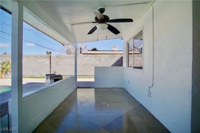 view of patio with fence and a ceiling fan