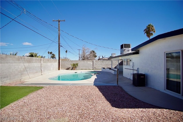 view of pool with a patio, central AC unit, a fenced backyard, and a fenced in pool