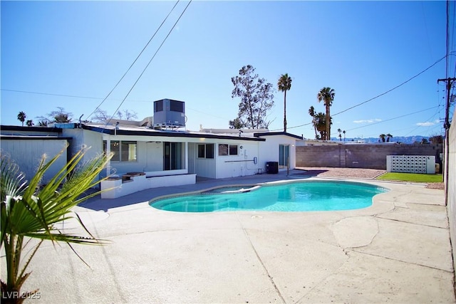 view of swimming pool with a fenced in pool, a patio, central AC unit, an in ground hot tub, and a fenced backyard