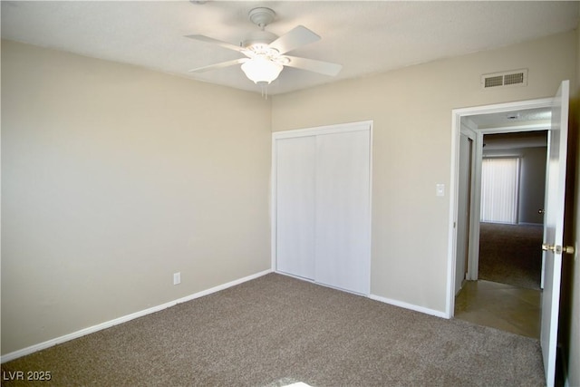 unfurnished bedroom featuring carpet, a closet, visible vents, and baseboards