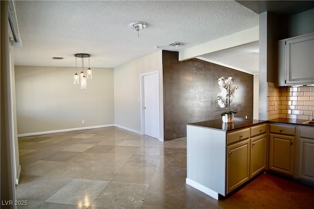 kitchen featuring vaulted ceiling with beams, a textured ceiling, tasteful backsplash, dark countertops, and pendant lighting