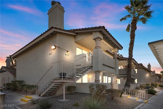 property at dusk with stairs