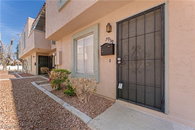 view of exterior entry featuring stucco siding