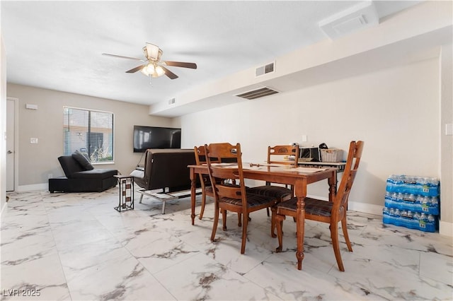 dining area with visible vents, ceiling fan, marble finish floor, and baseboards