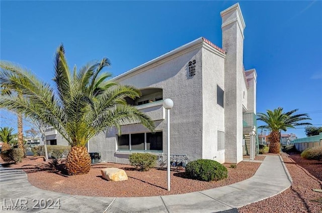 view of side of property with stucco siding